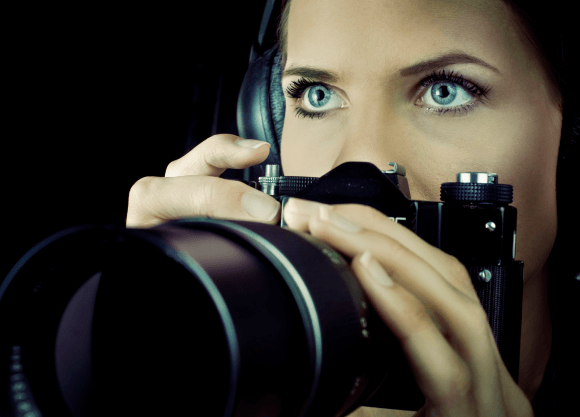 SydneyPI - SydneyPI - Female Private Investigator Using a Camera. A female investigator holding a camera and taking discreet photos in a professional, lawful surveillance context.